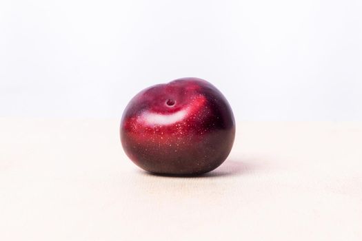 Red plum fruit on the white background isolated