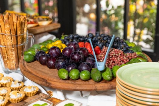 Fruits on wooden plate close up