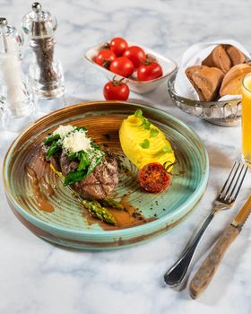 Tasty steak with potato, tomato