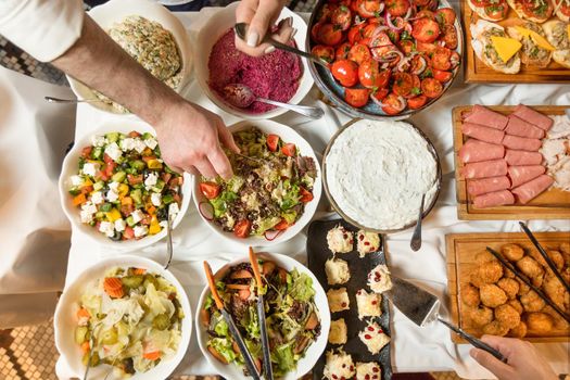 Hands on a big breakfast table