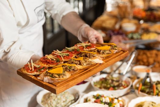 Man taking food from breakfast table at the restaurant