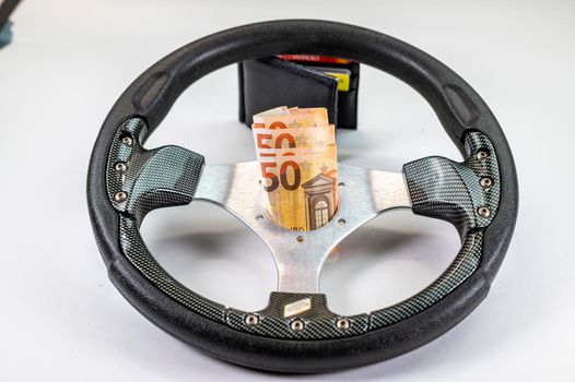 sport racing steering wheel with 50 euro banknotes with white background