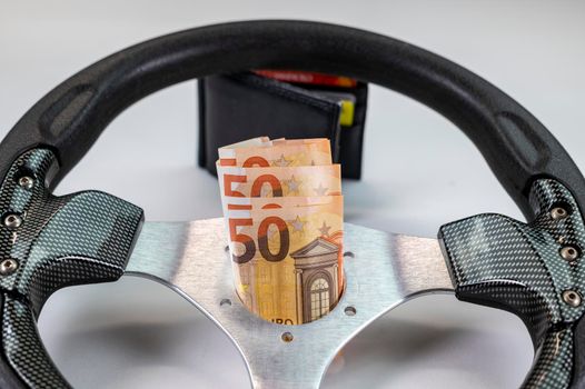 sport racing steering wheel with 50 euro banknotes with white background