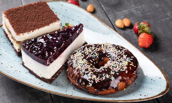 Beautiful doughnut, chocolate cake, tiramisu, top view