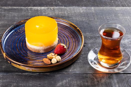 Beautiful yellow dessert with glass of tea