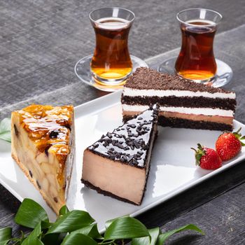 Beautiful chocolate cakes with glass of tea