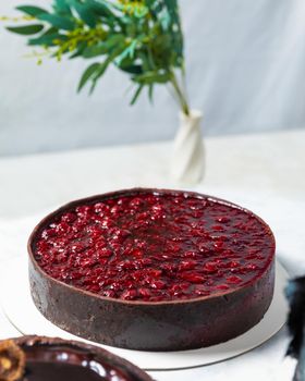 Beautiful red jam cake on the white background, close up