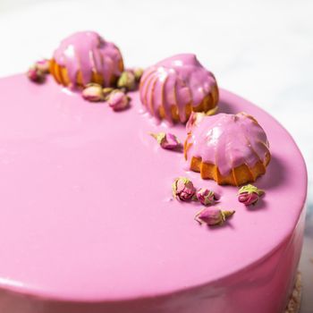 Beautiful pink cream cake on the white background, close up