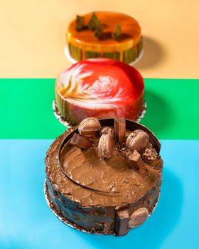 Different beautiful macaron, honey, jam cakes on the colorful background