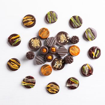 Chocolate pieces on the white background, top view