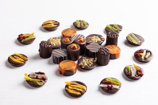 Chocolate pieces on the white background, top view