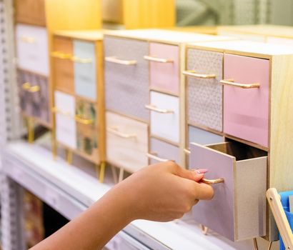 Woman opening small colorful wardrobe