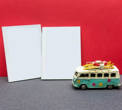 White postcard book with a car with a red background