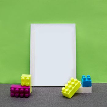 White postcard book with a green background