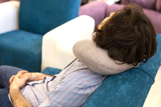 Man sleeping with a nap pillow