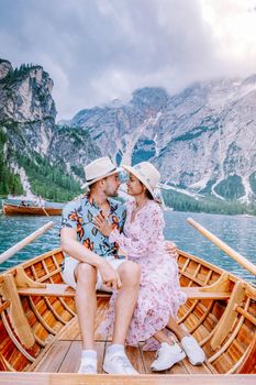 couple visit the famous lake Lago Di Braies Italy, Pragser Wildsee in South Tyrol, Beautiful lake in the italian alps, Lago di Braies. men and woman on vacation italian alps