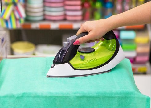 Woman ironing close up at the store