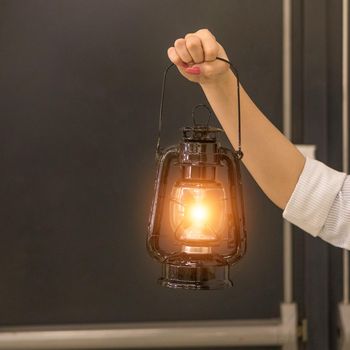 Woman holding a old Light Lantern