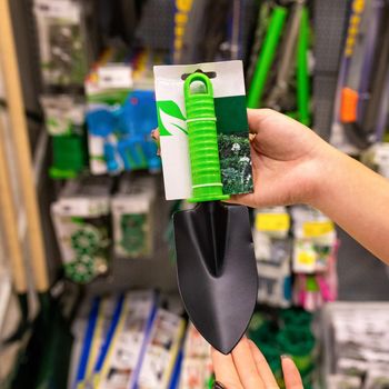 Holding new trowel at the store