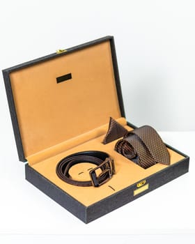 Brown classic belt with a tie in the box