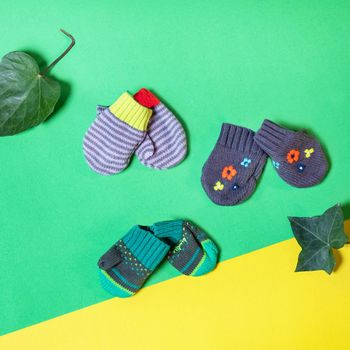 Warm winter children's gloves isolated on colorful background