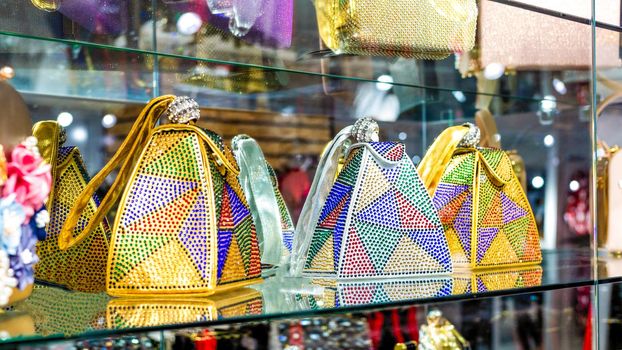 Colorful shiny women handbags in a store