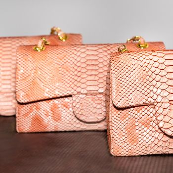 Pink decorated female bag on a white background isolated