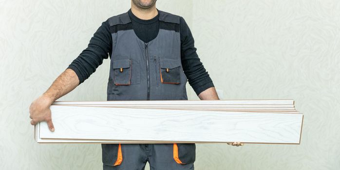 Worker man holding white wood laminate