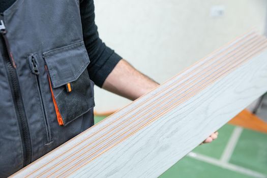 Worker man holding white wood laminate