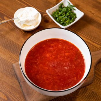 Tasty red borscht soup with yogurt
