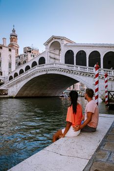 couple men and woman on a city trip to Venice Italy, colorful streets with canals Venice. Europe