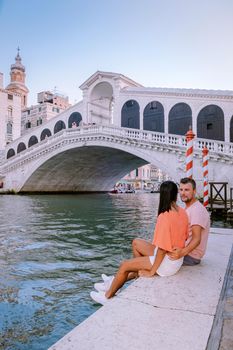 couple men and woman on a city trip to Venice Italy, colorful streets with canals Venice. Europe