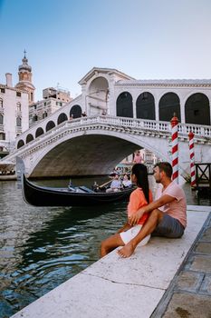 couple men and woman on a city trip to Venice Italy, colorful streets with canals Venice. Europe