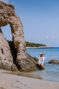 Tropical beach of Voulisma beach, Istron, Crete, Greece ,Most beautiful beaches of Crete island -Istron bay near Agios Nikolaos young asian woman mid age on vacation Greece Crete