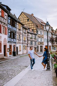 couple on city trip Colmar, Alsace, France. Petite Venice, water canal and traditional half timbered houses. Colmar is a charming town in Alsace, France. Beautiful view of colorful romantic city Colmar