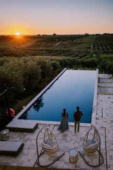 Luxury resort with a view over the wine field in Selinunte Sicily Italy. infinity pool with a view over wine fields in Sicilia, couple on vacation at luxury resort