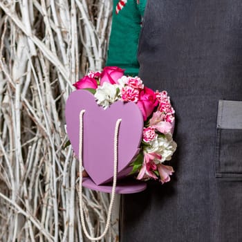 Man holding beautiful pink flower bouquet