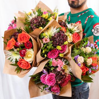 Florist holding beautiful flower bouquets