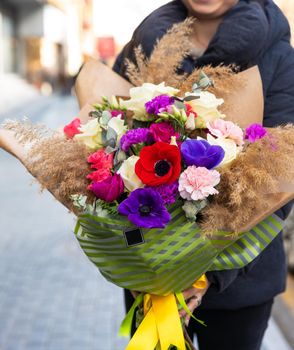 Woman holding beautiful flower bouquet