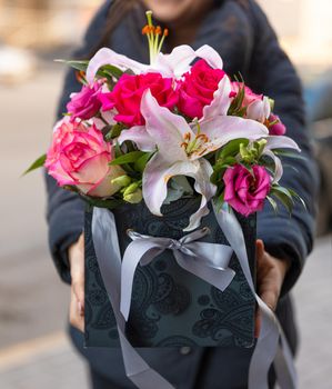 Woman holding beautiful flower bouquet in the box