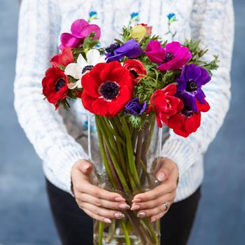 Woman holding red, magenta, pink Papaver rhoeas, Common poppy flower bouquet