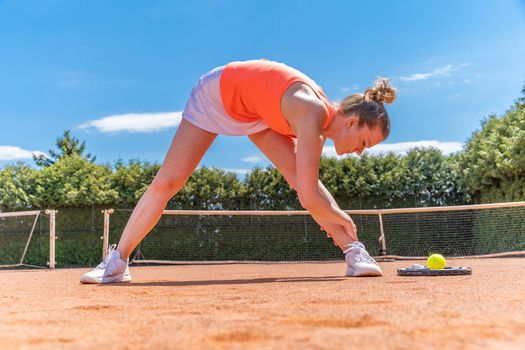 Warming up and stretching before a game of tennis on the court.