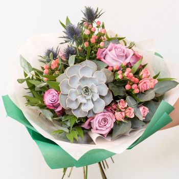 Woman holding beautiful flower bouquet