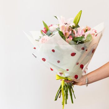 Woman holding colorful flower bouquet with white background