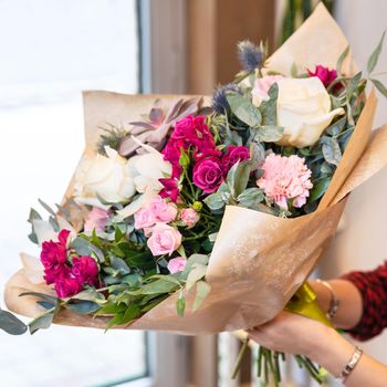 Florist woman holding beautiful flower bouquet