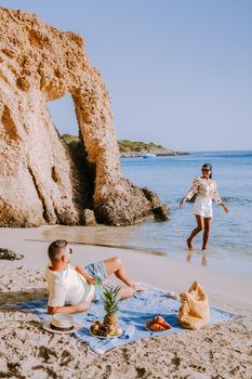 Tropical beach of Voulisma beach, Istron, Crete, Greece ,Most beautiful beaches of Crete island -Istron bay near Agios Nikolaos young couple mid age on vacation in Greece Crete