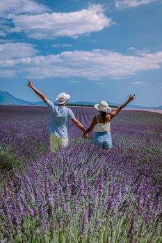 Provence, Lavender field France, Valensole Plateau, colorful field of Lavender Valensole Plateau, Provence, Southern France. Lavender field. Europe. Couple men and woman on vacation at the provence lavender fields,