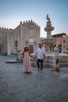 Taormina Sicily, Belvedere of Taormina and San Giuseppe church on the square Piazza IX Aprile in Taormina. Sicily, Italy. Couple on vacation at the Italian Island Sicily