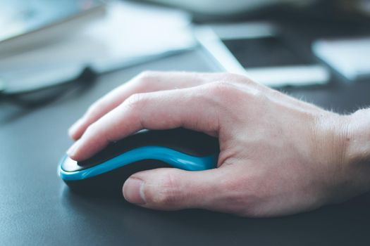 Close up of computer mouse used by a male hand
