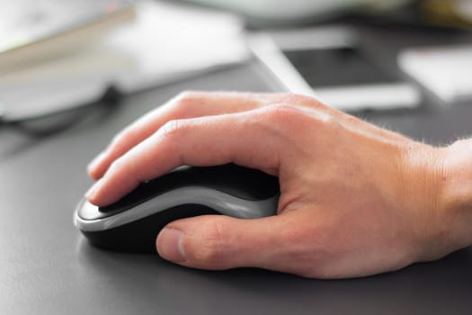 Close up of computer mouse used by a male hand